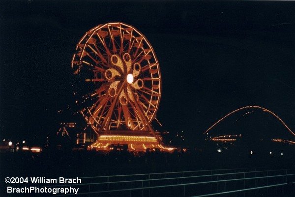 Ferris Wheel and Lightning Racer at night.