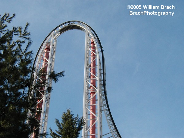 Those red tubes were air storage tanks.  HyperSonic XLC was a launched coaster that used compressed air to send the coaster trains over the top hat.  Randomly programmed into the ride were failed launches where the train would fail to crest the hill and roll back.  Those riders would get treated to a second and successful launch to go over the top hat.