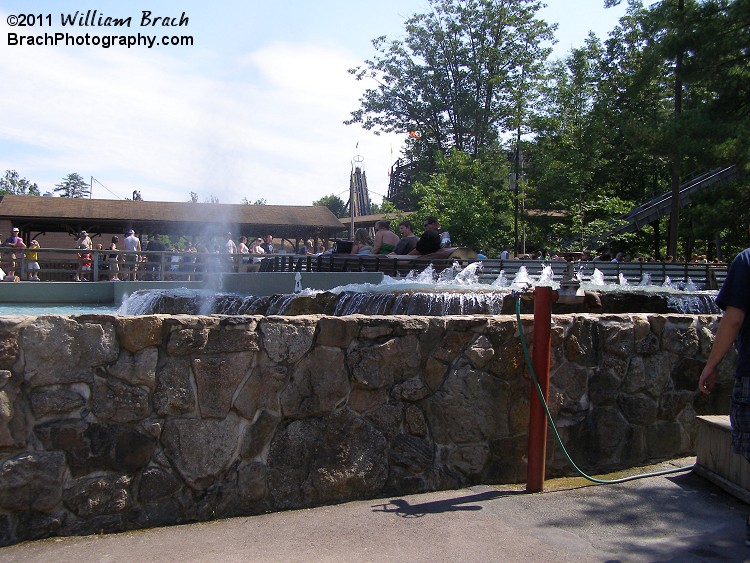 Flume riders getting soaked by water cannons!
