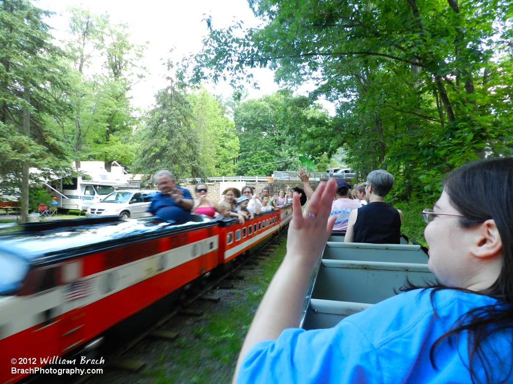 Waving at the other train passing by.